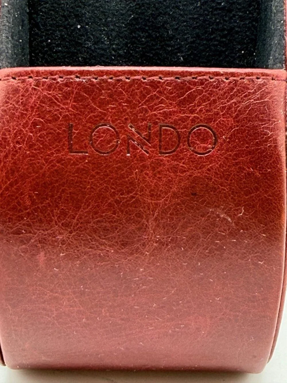 red Londo brand remote control holder features five compartments for organizatio